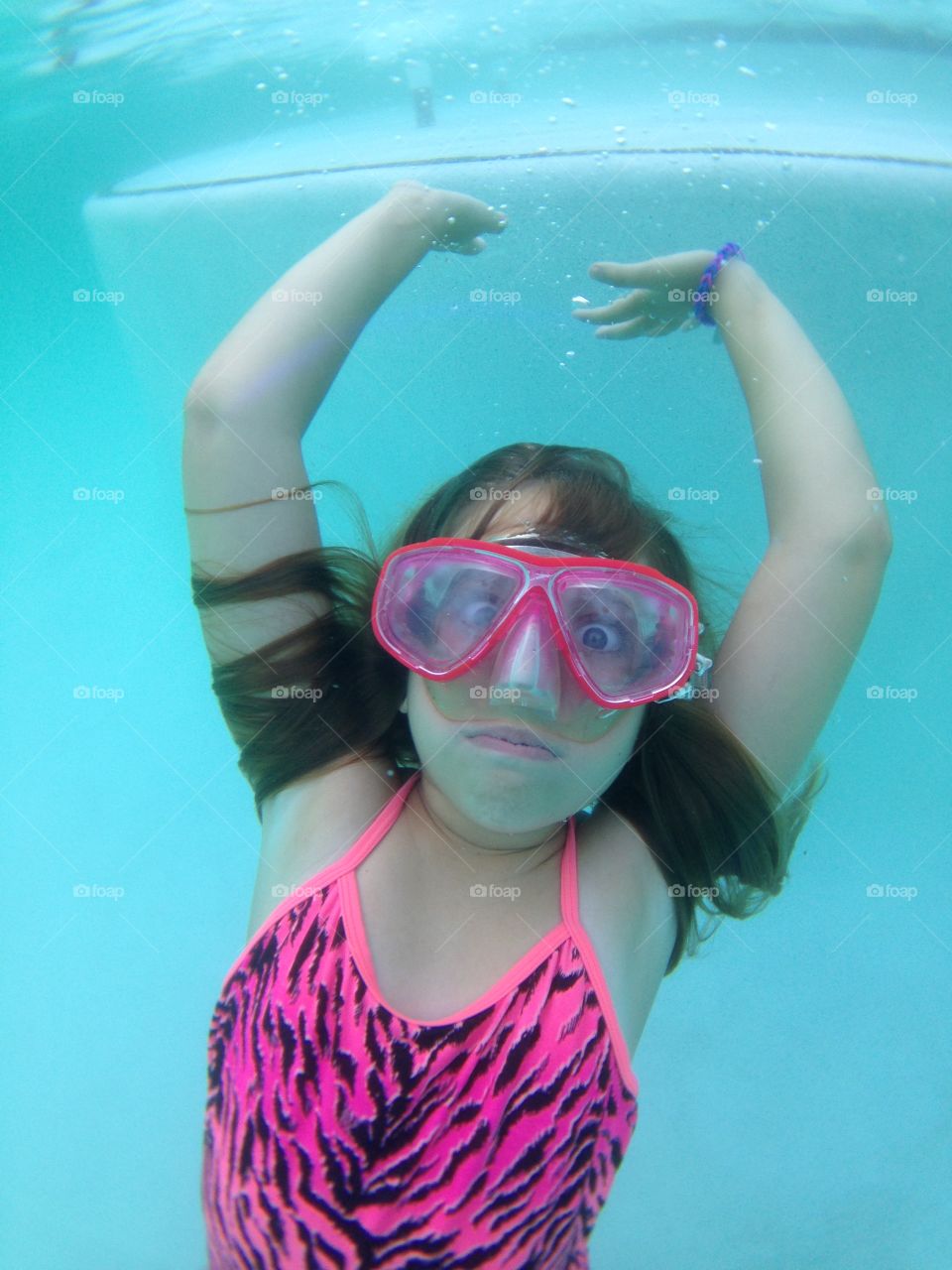 Young girl swimming underwater