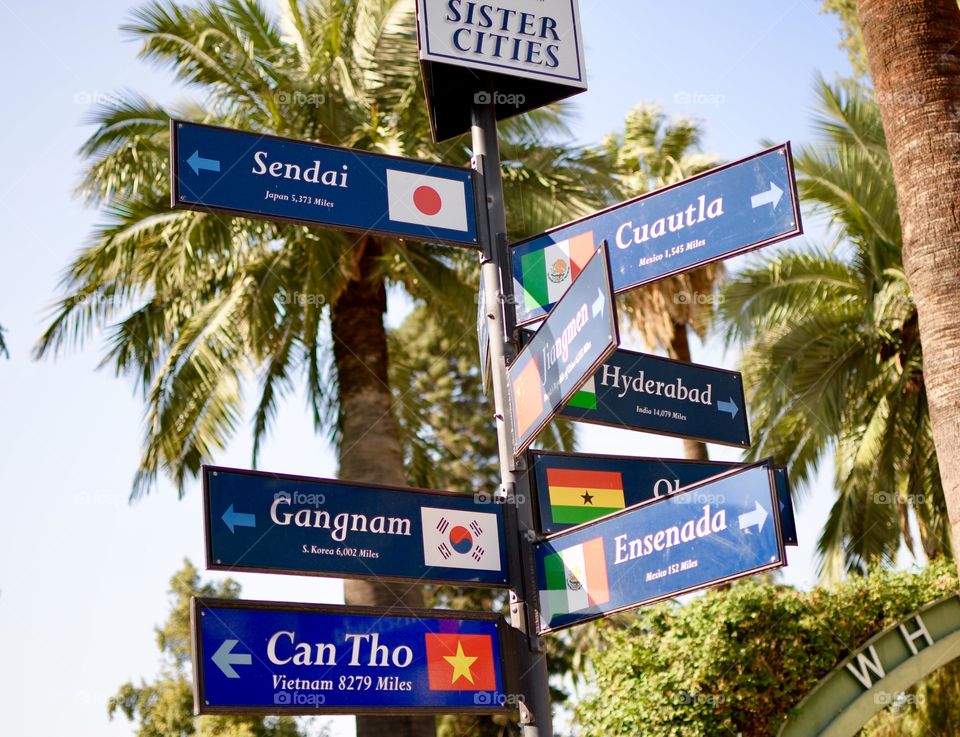Street signs with different cities on them