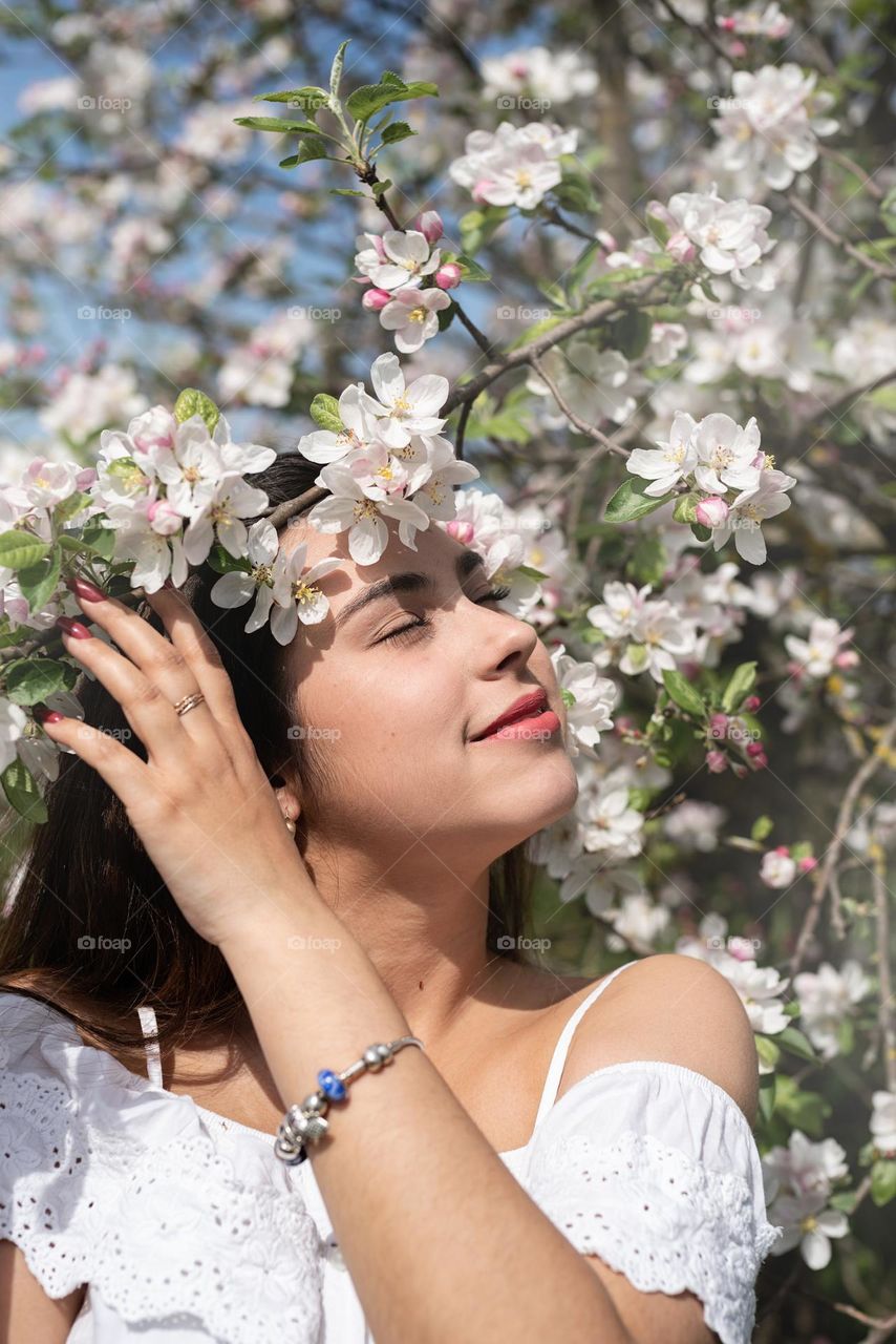 beautiful woman in spring blossom trees