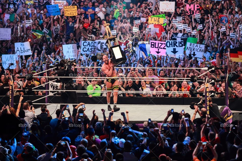 WWE wrestler on the stage with award cup