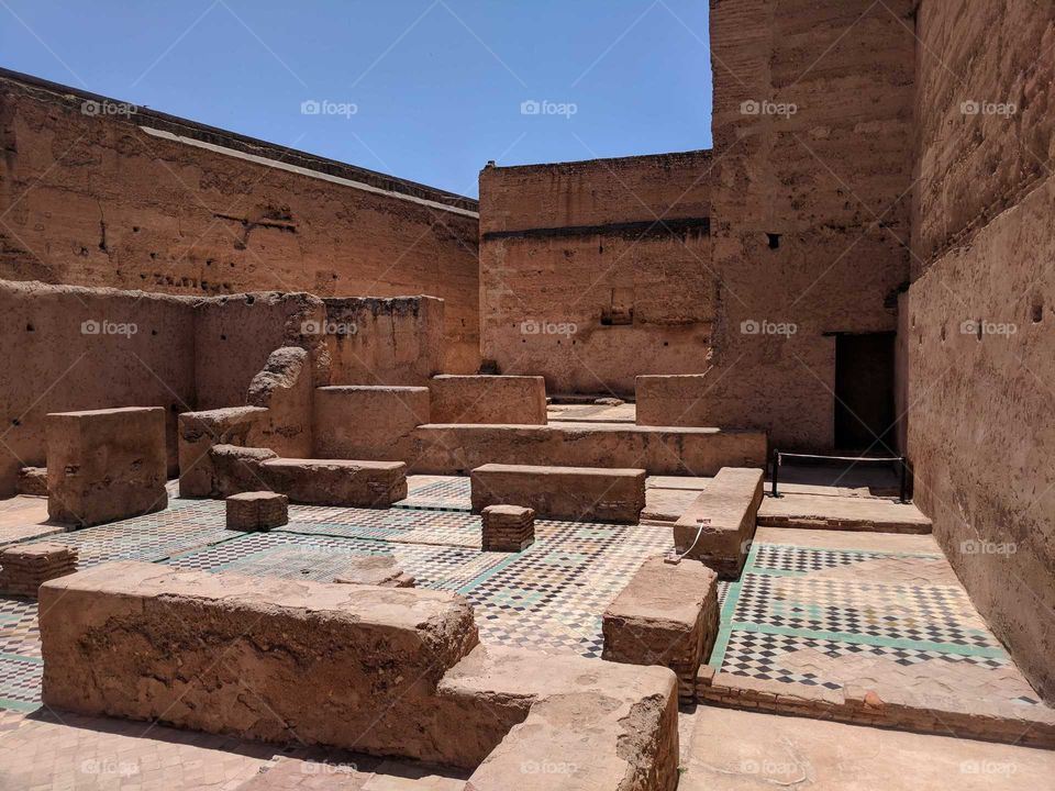Ancient Ruins at the Palais El Badi, a Palace in Marrakech in Morocco - Colorful Ceramic Tile Mosaic Floors and Brown Clay and Stone Walls Surrounded What Used to be Rooms in the Palace