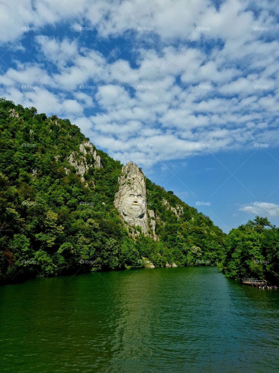 clouds spread over the sculpture of Decebal's face