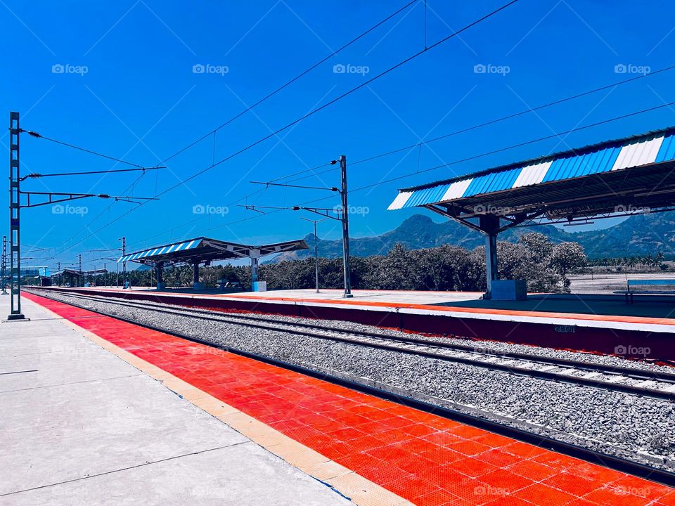 An empty railway platform - waiting for the train and people 