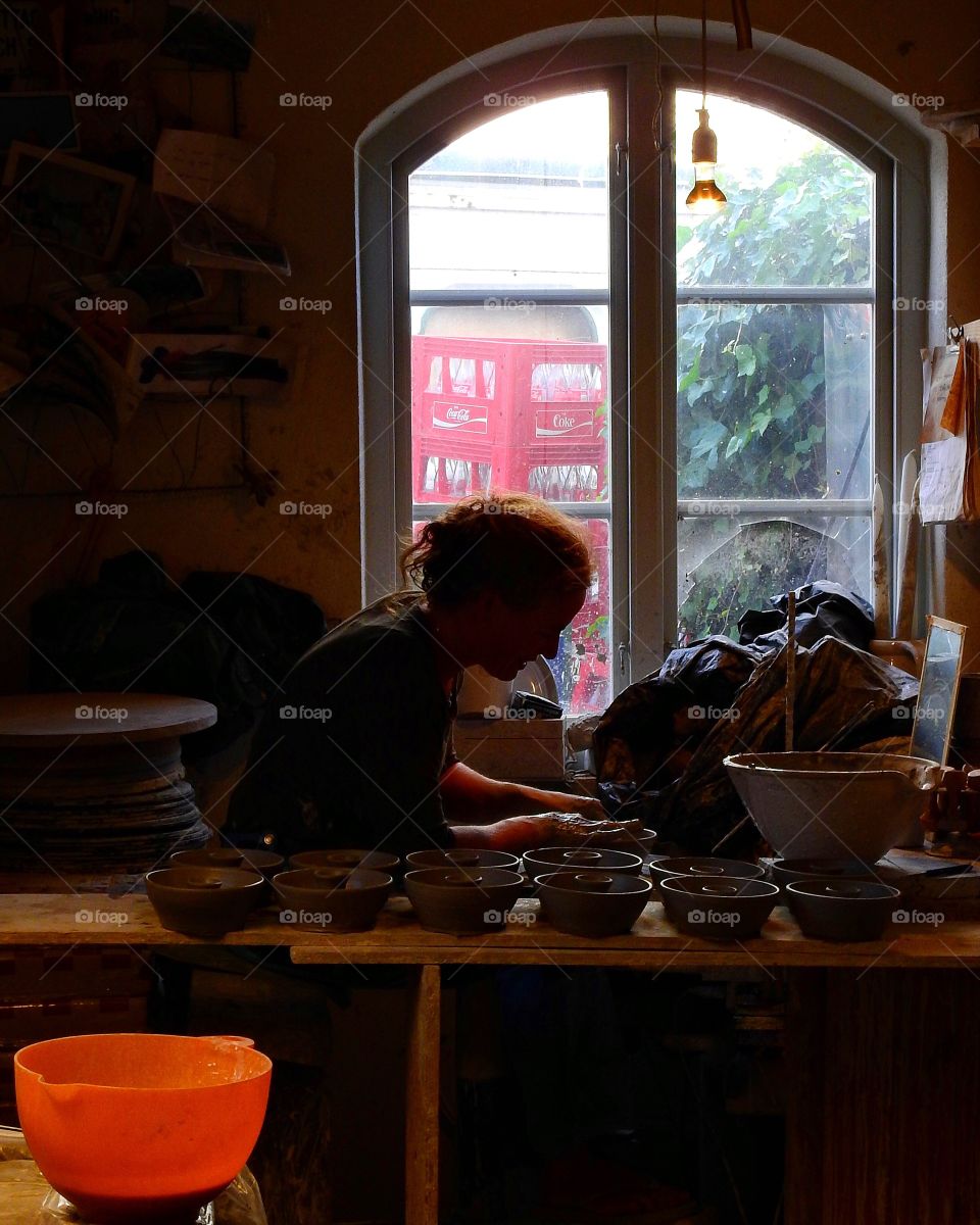 Artist making candleholders