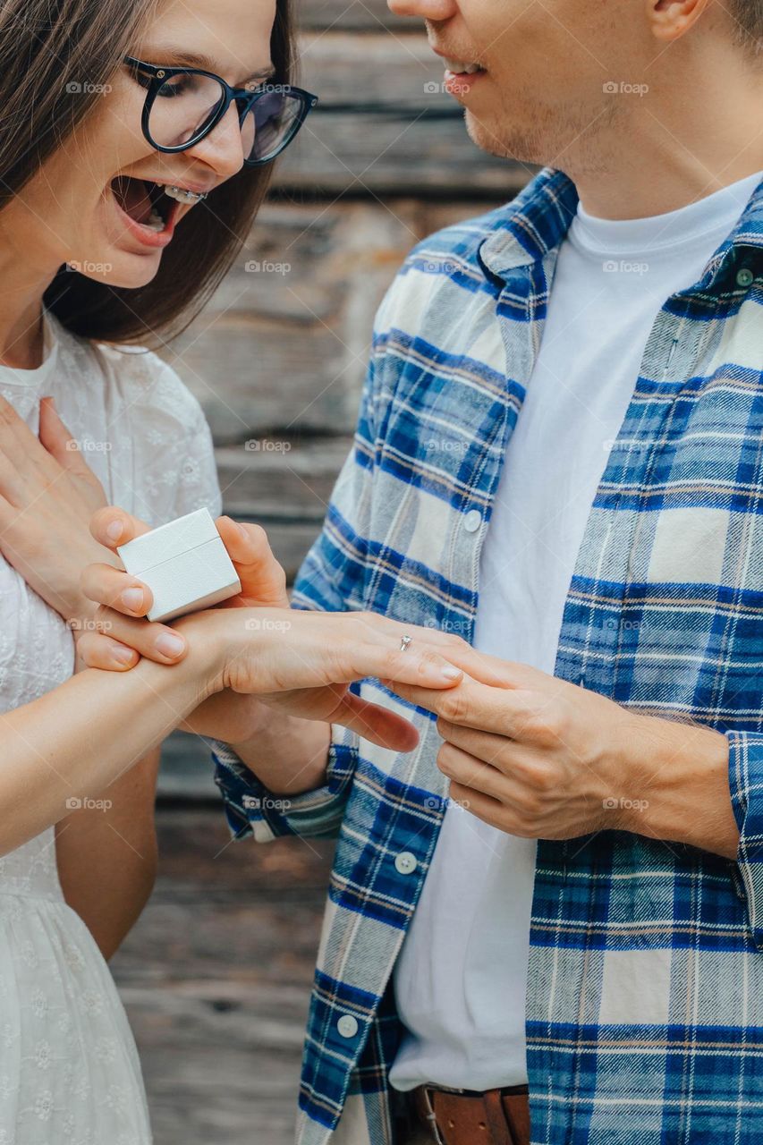 Surprised woman getting marriage proposal 