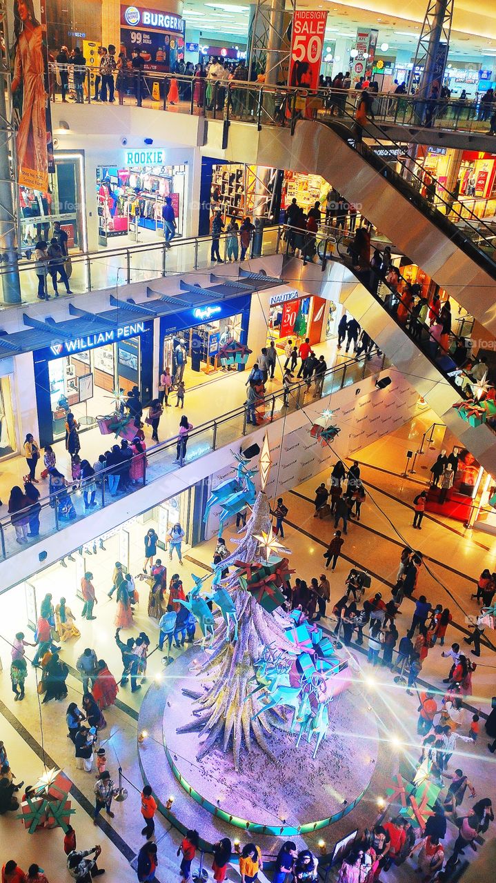 Urban life=Causal Evening. Oberoi Mall weekday crowd in a Christmas week with Reindeers coming to you with loads of gifts. Urban life is in layers as these floors, sometimes you get elevation and sometimes stairs still you have to make your own way.