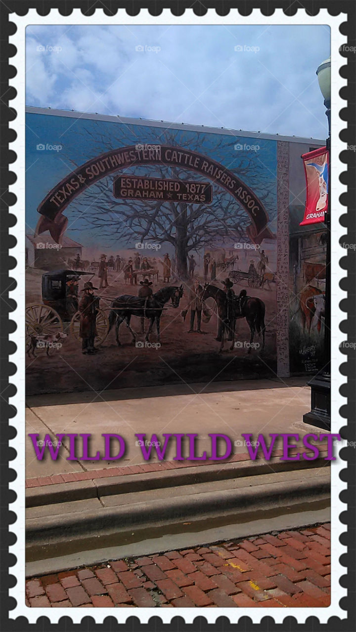 old west mural. this is a mural painted on a local buisness