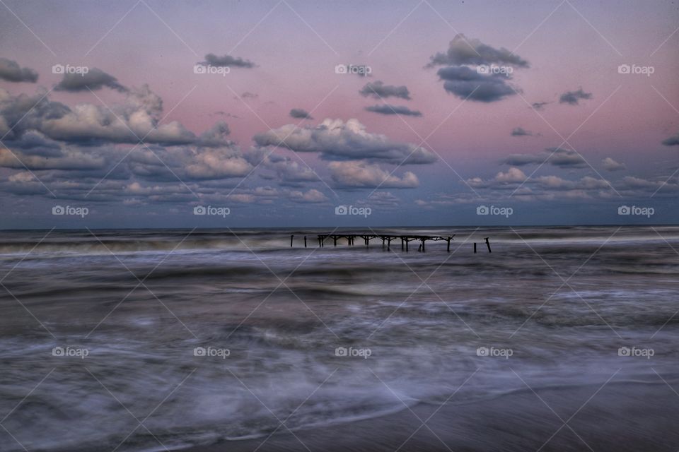 Broken jetty in wavy Black Sea side