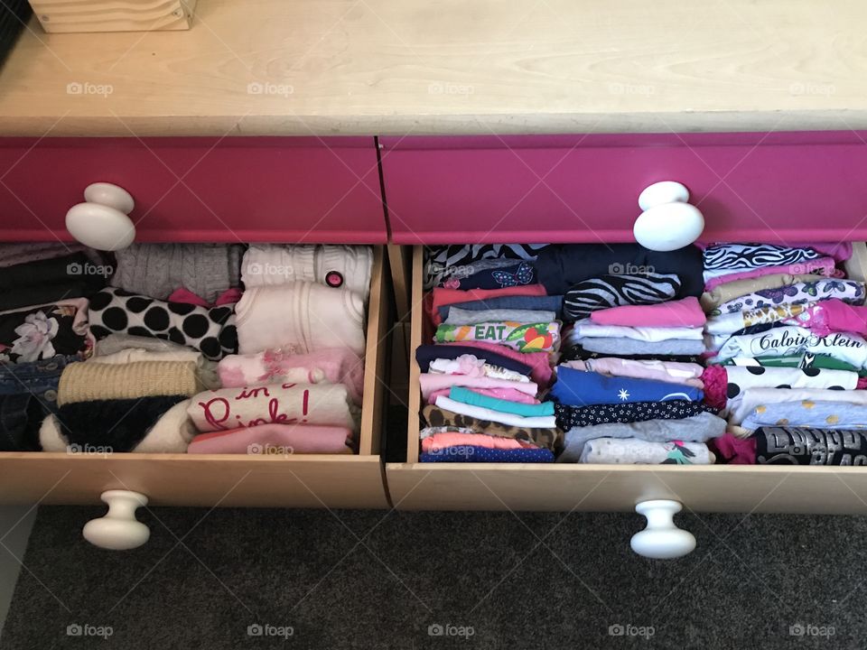 Well folded children’s clothing in a dresser, space saving, organized