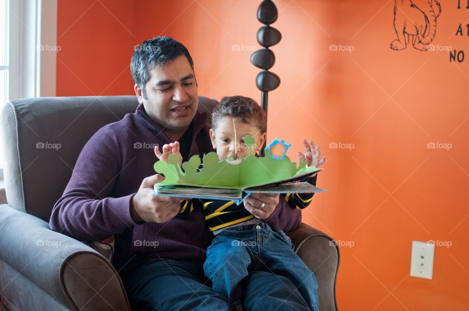 Dad reading book with toddler
