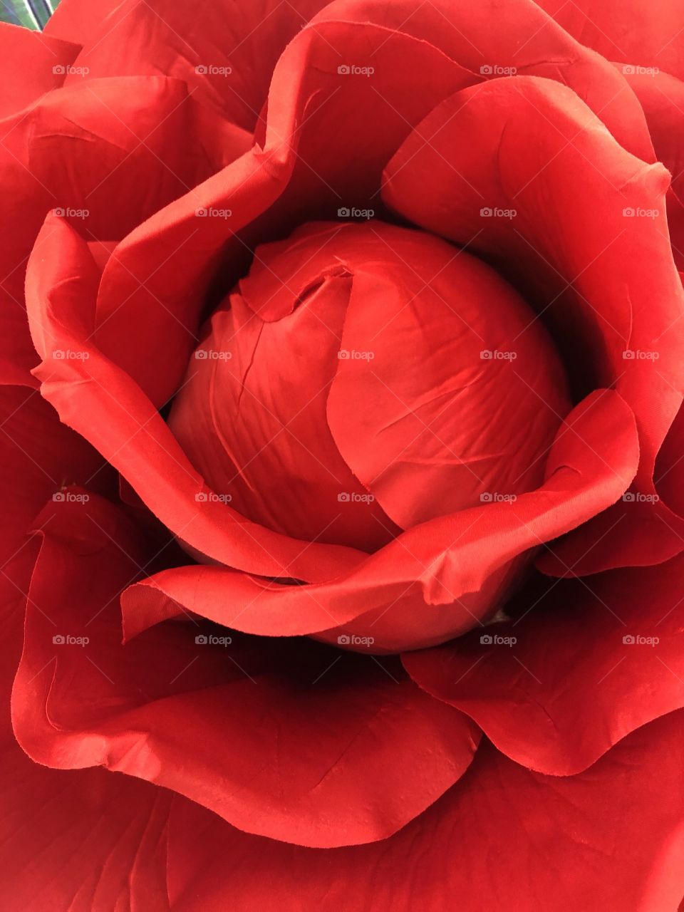 Closeup of a bright red  beautiful fabric rose. 