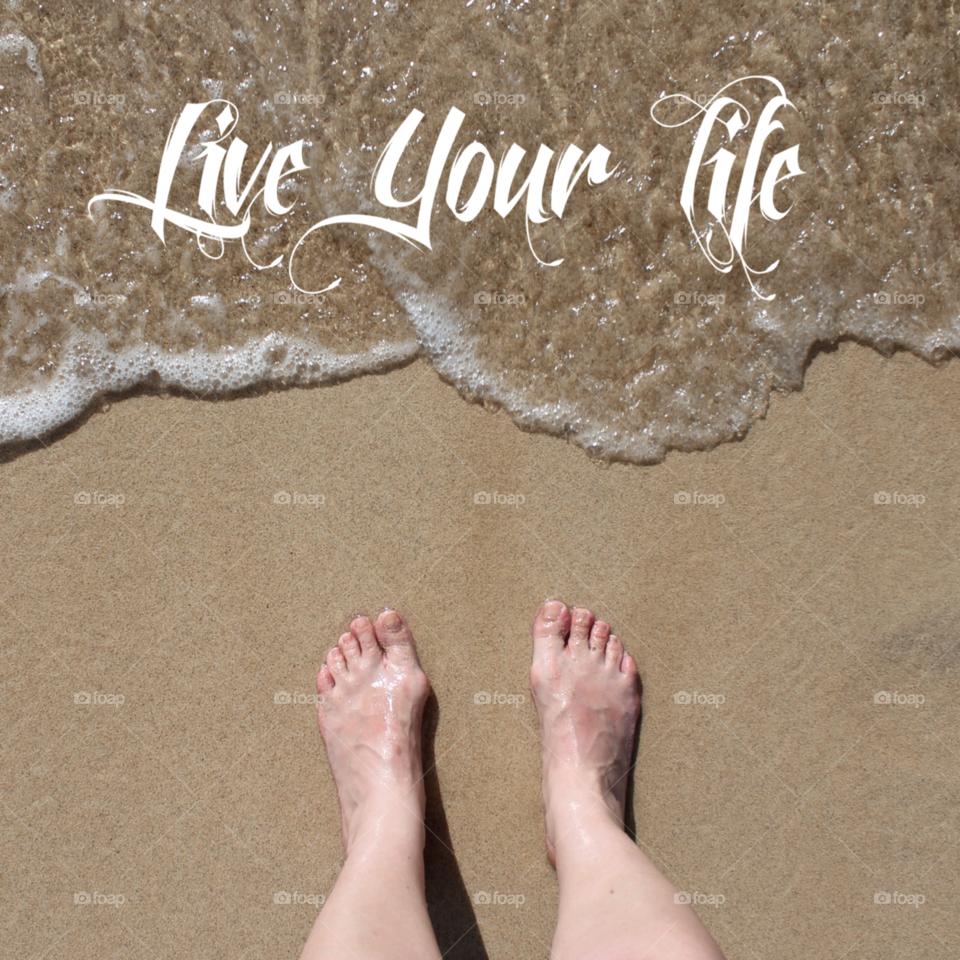 Feet on sand beach water ocean live your life text adventure explore
