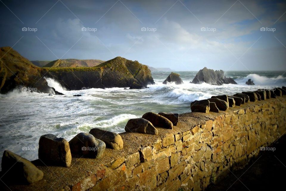 Stone wall holding back a choppy sea