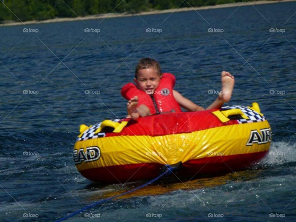 Boy tubing on a lake