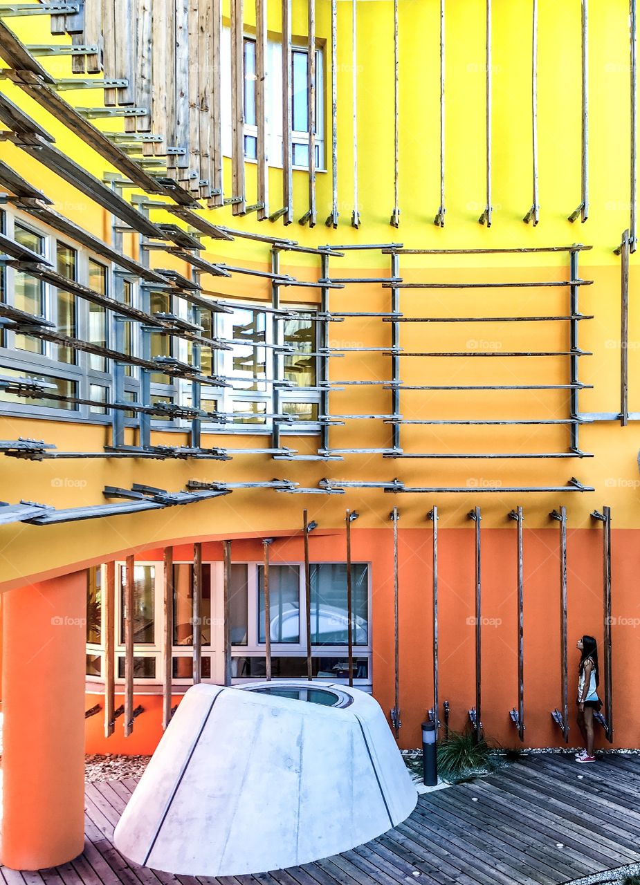 Woman standing beside building