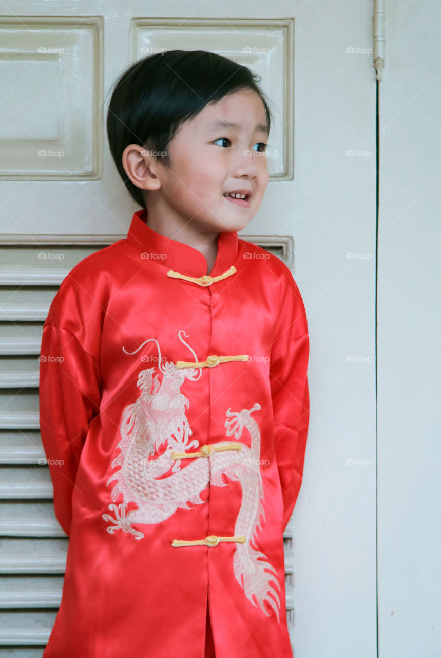 celebrate Chinese new years with the red and gold colour of clothes