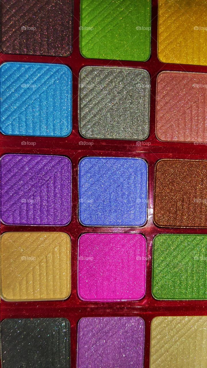 Close view of different colour eyeshadows in the eyeshadow palette.