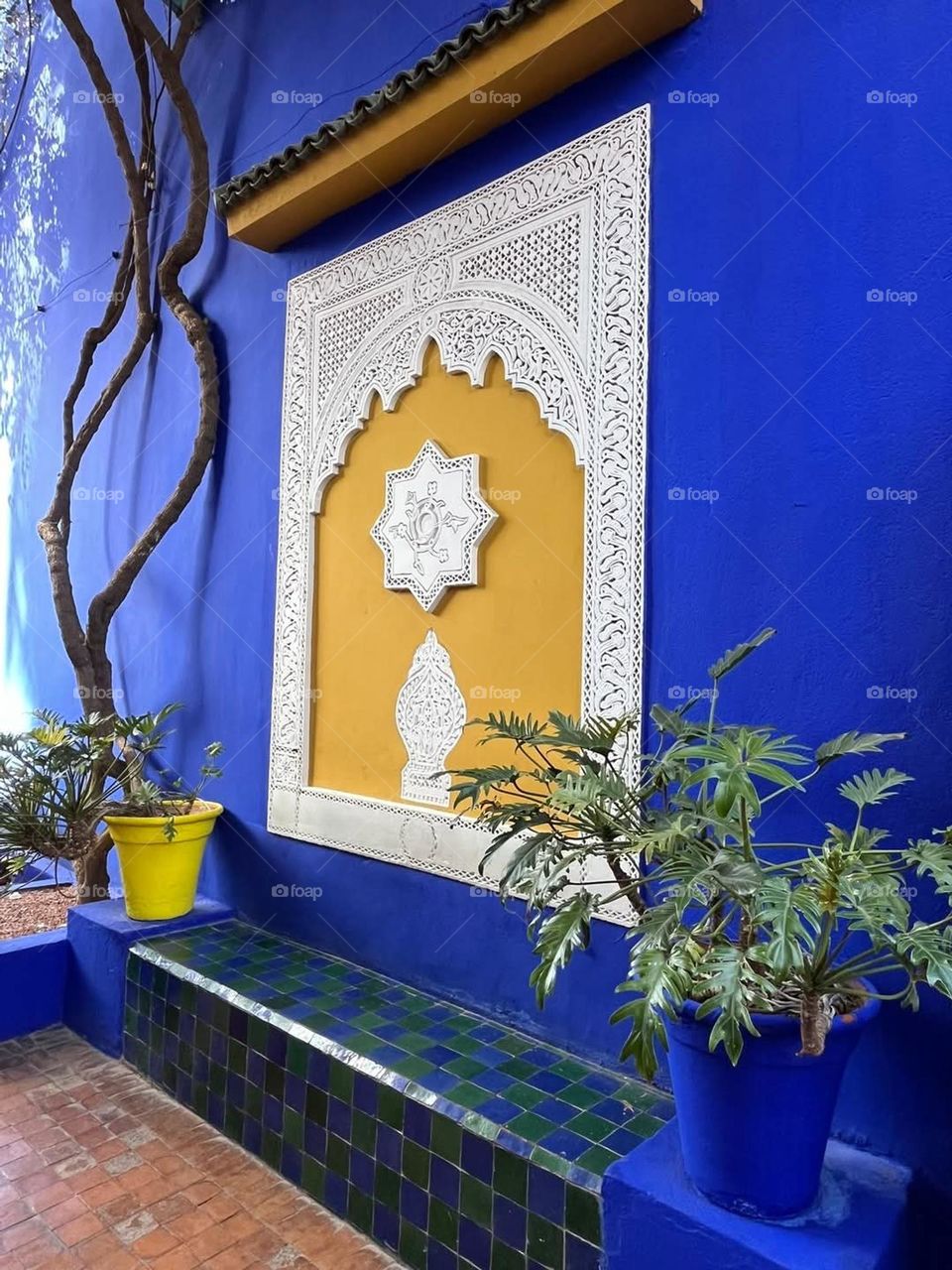 Close up on one of the blue and yellow walls of Majorelle gardens in Marrakech