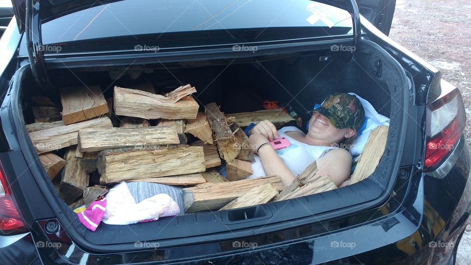 Fun moment. Girl bury under wood in the trunk