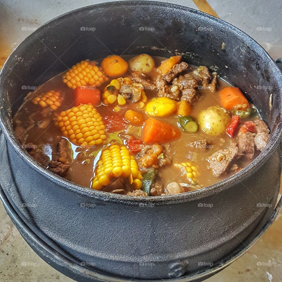 traditioal south african "potjie kos" being cooked