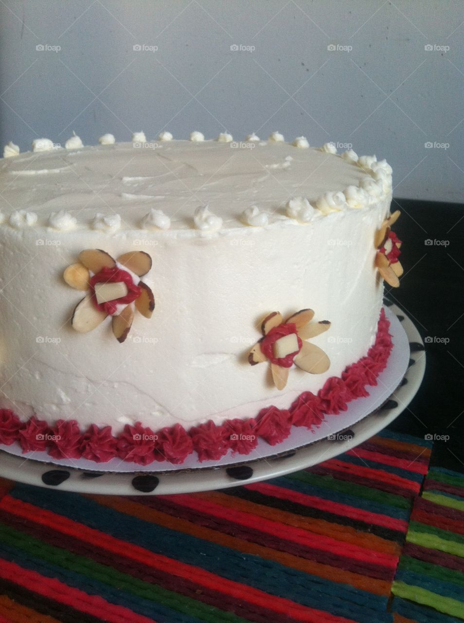 Cake. White frosted cake with sliced almond flowers