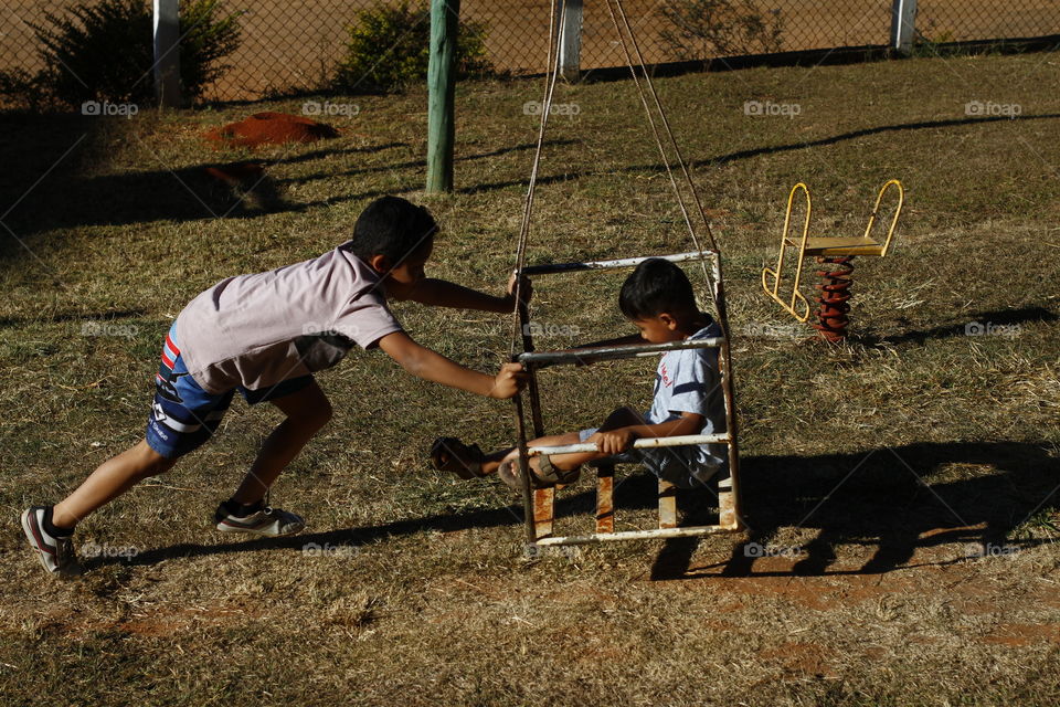 two brothers playing in the park