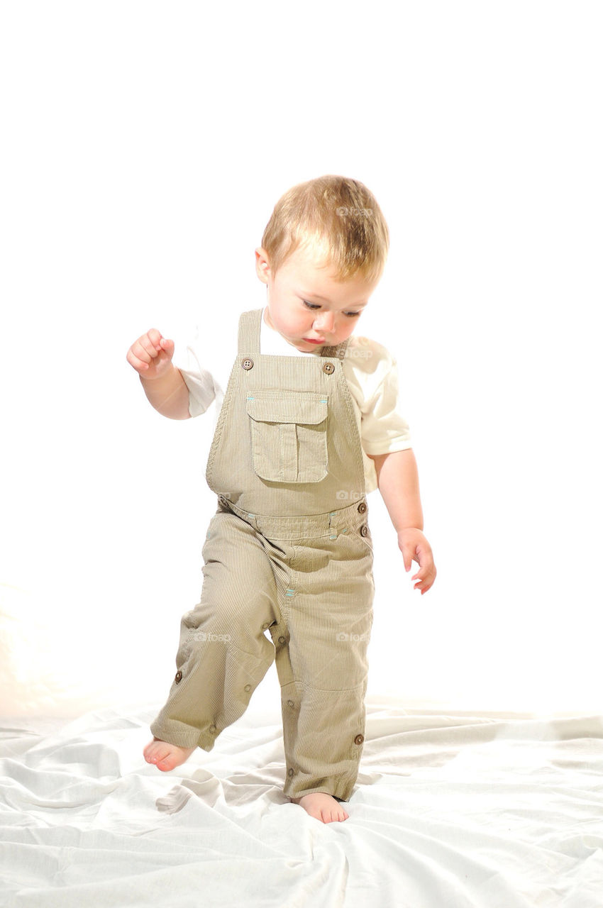 UPRIGHT, FULL-LENGTH SHOT OF YOUNG WHITE BOY WITH ONE ARM AND ONE LEG
