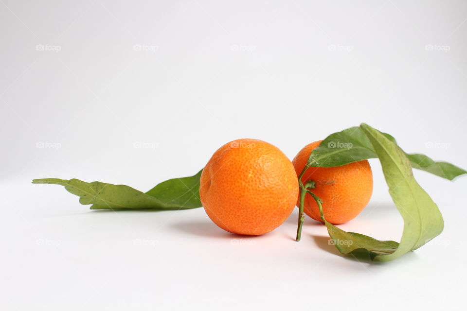 two Mandarin and green leaves