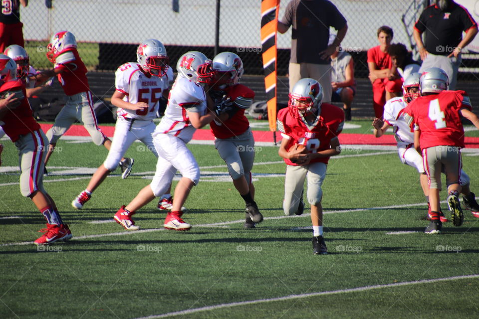 Boys playing in football game