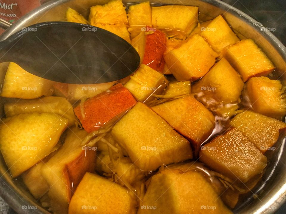 Boiling pumpkin pieces to make homemade pumpkin pie 