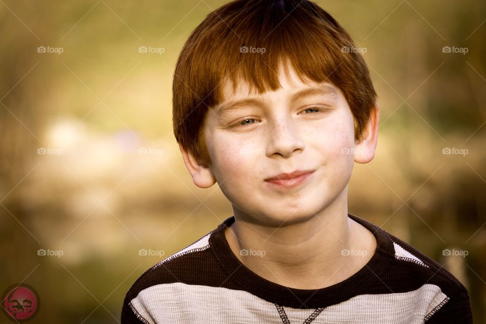 Happy redhead boy. Portrait of a smiling redheaded boy during the summer. 