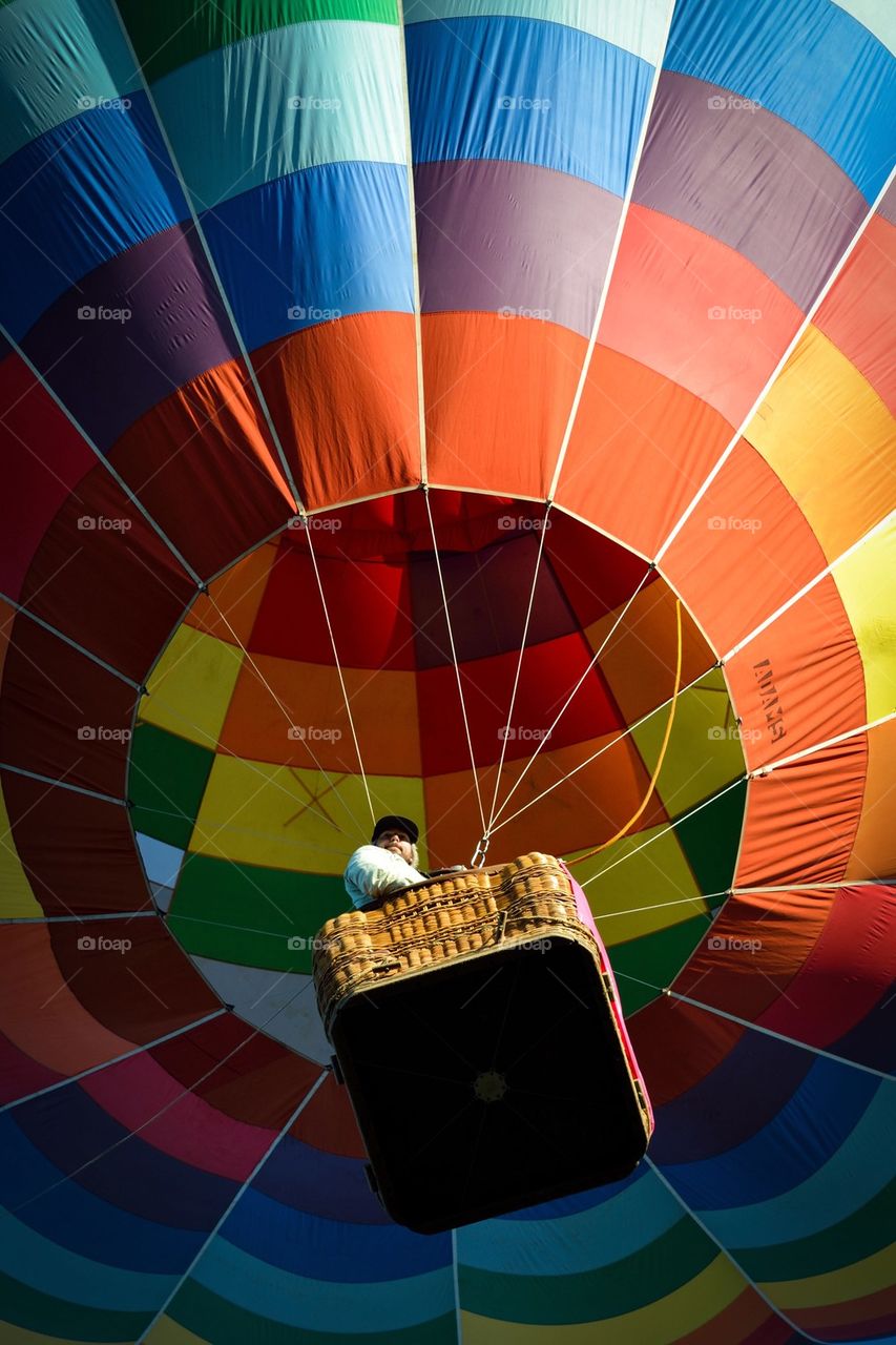 Low angle view of person sitting on parachute