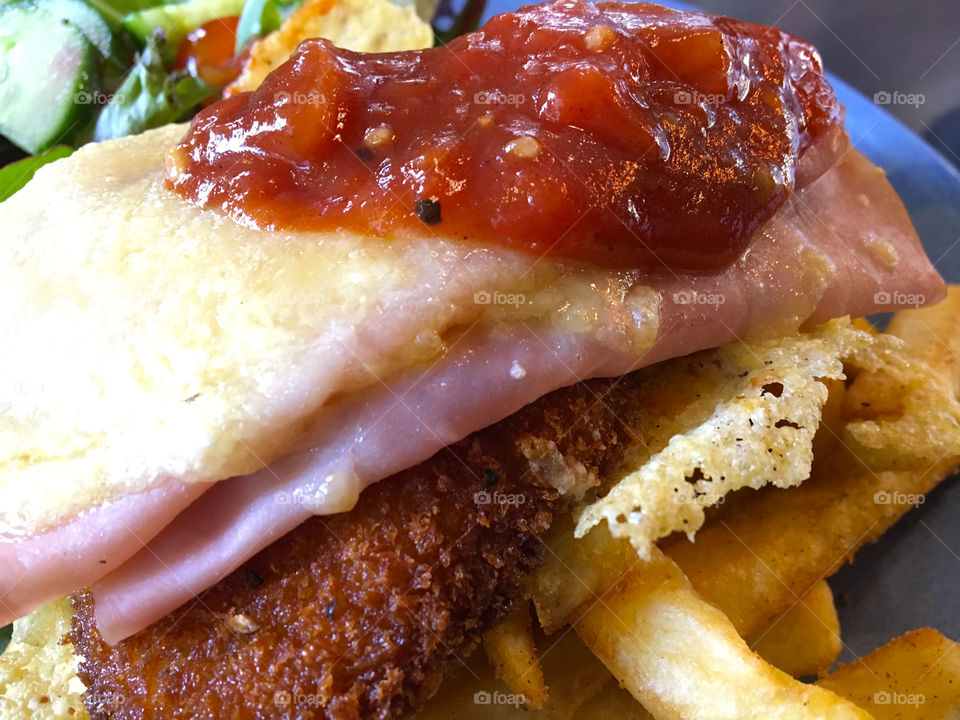Chicken parmigiana with chips and green salad.