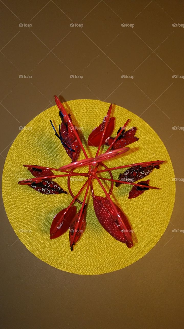 Red Ornaments on Stand on Yellow Placemat