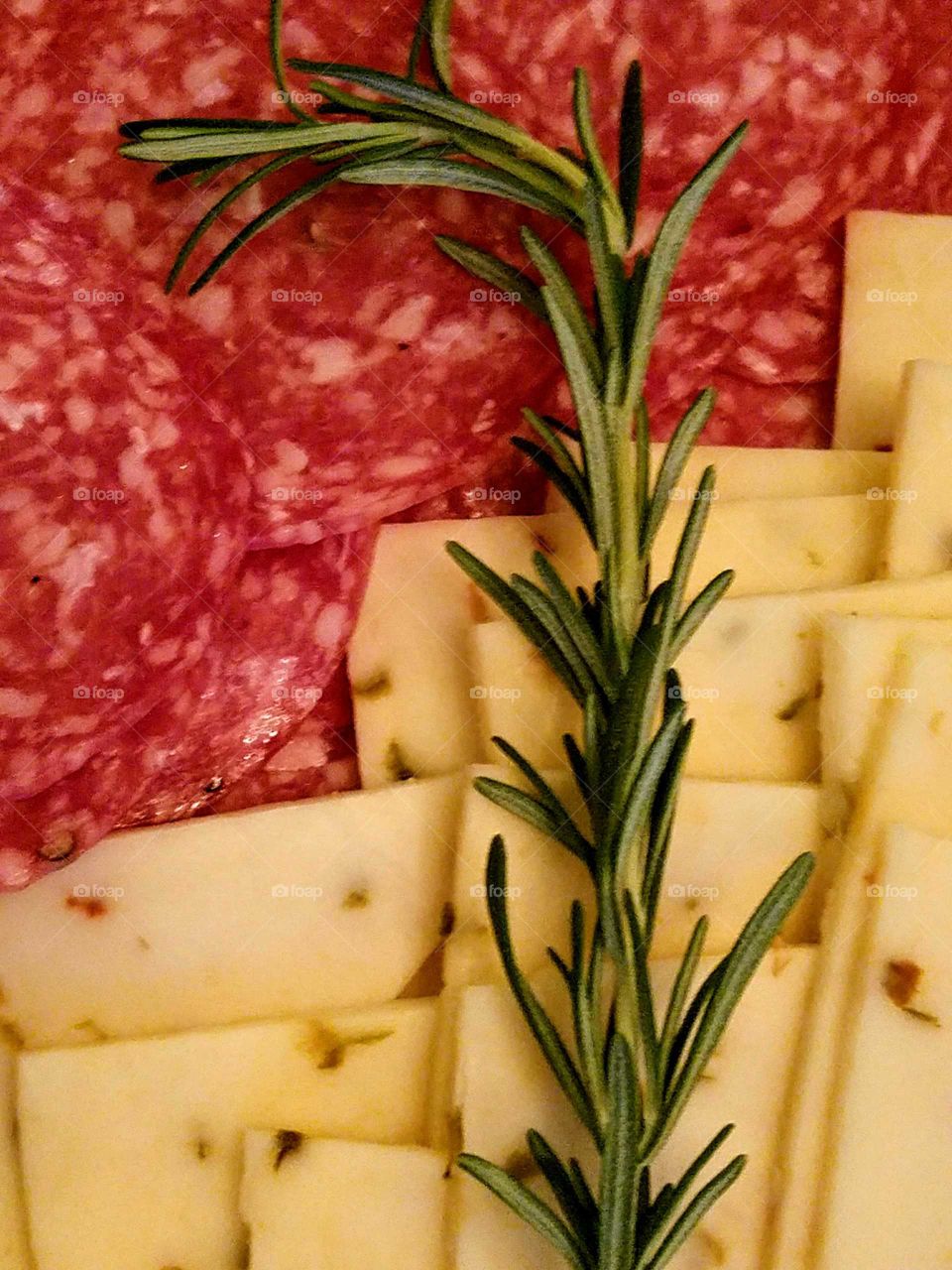 Slice of salami and pineapple with rosemary