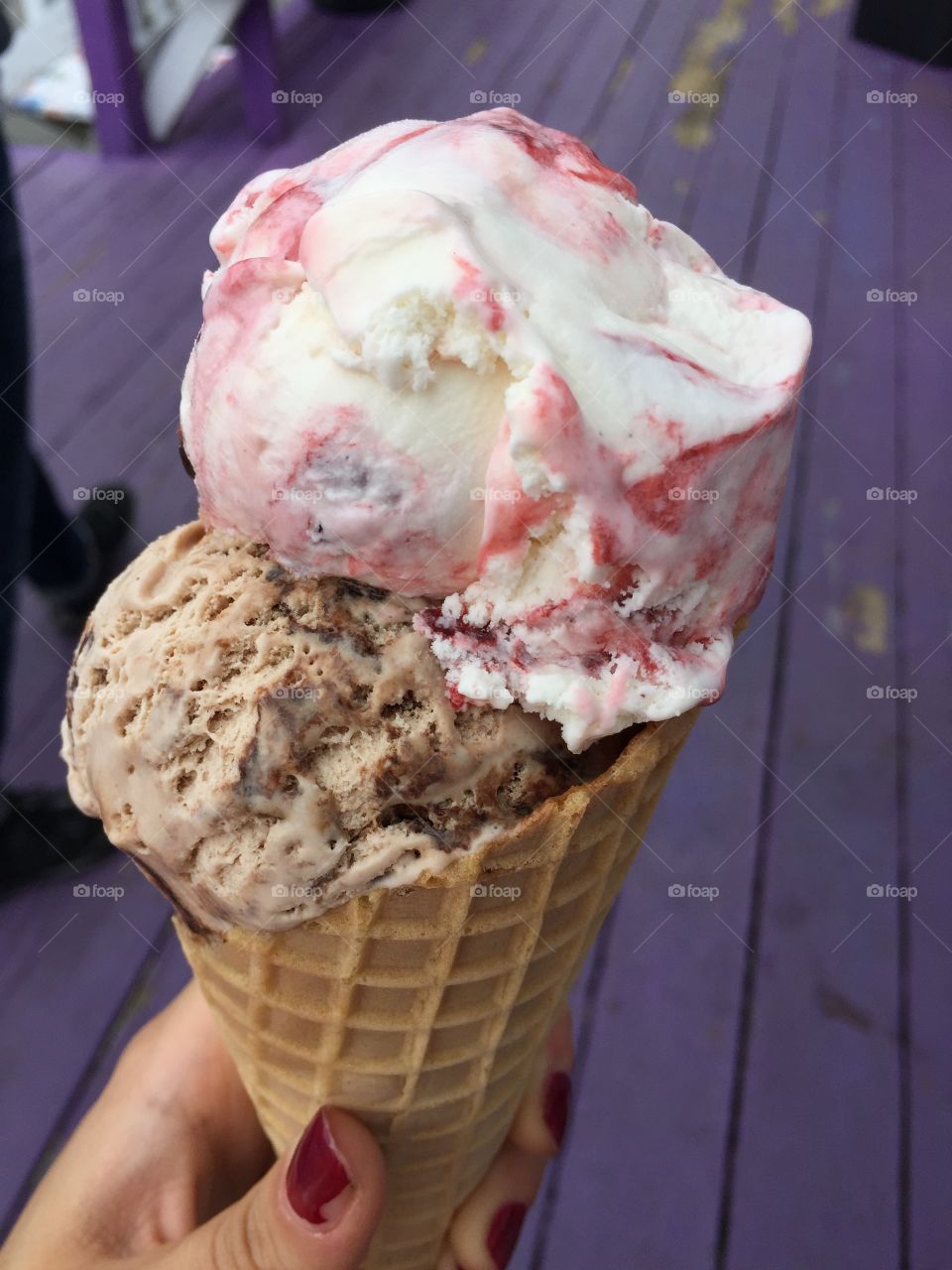 A different angle of two scoops on a waffle cone 