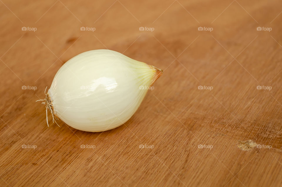 Single Onion On Wooden Table