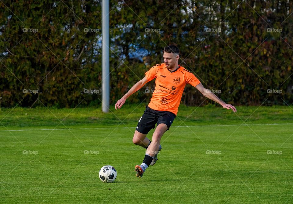 Football player kicking a ball during an official match