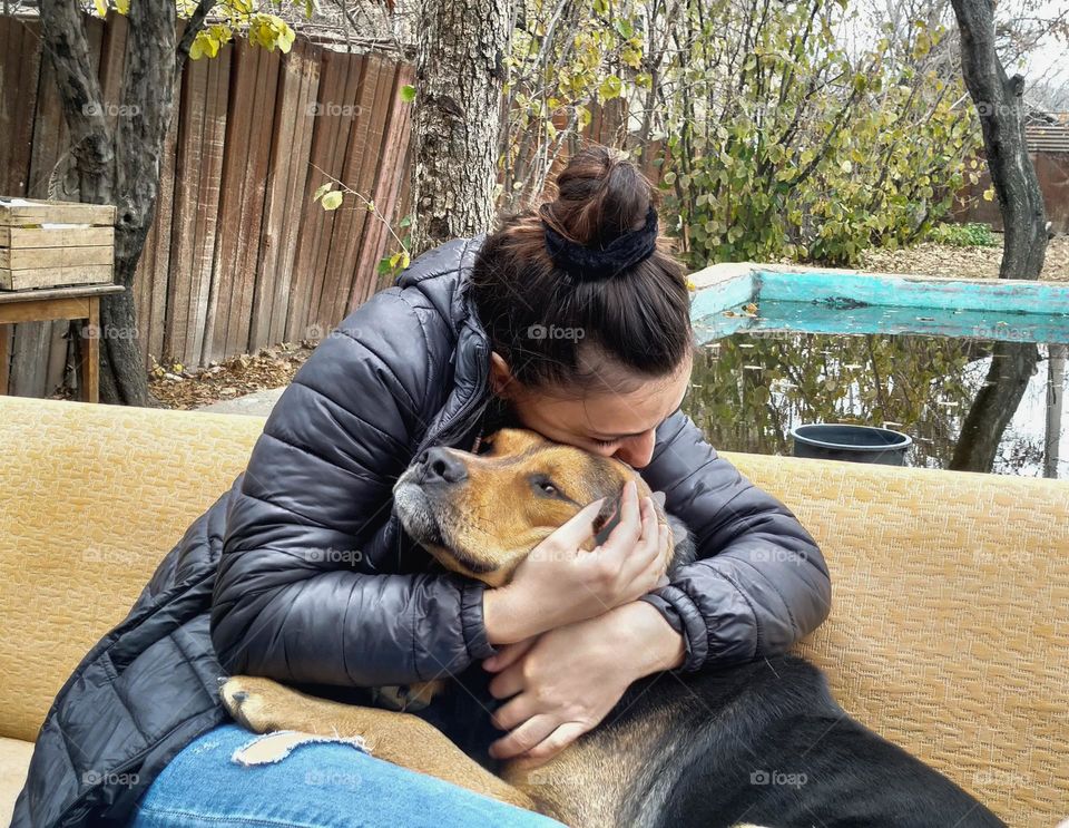 A girl hugs a dog