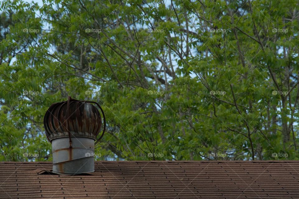 Rusted attic turbine exhaust on an old home 