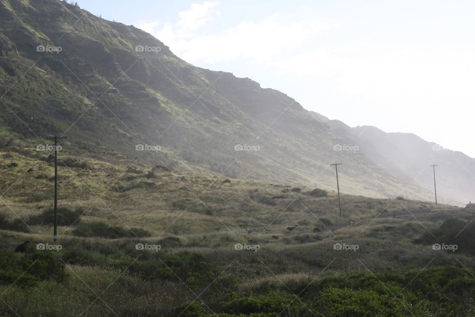 Telephone Poles Fade Away. Telephone poles fade into the distance along a trail that leads to Kaena Point on Oahu, Hawaii.