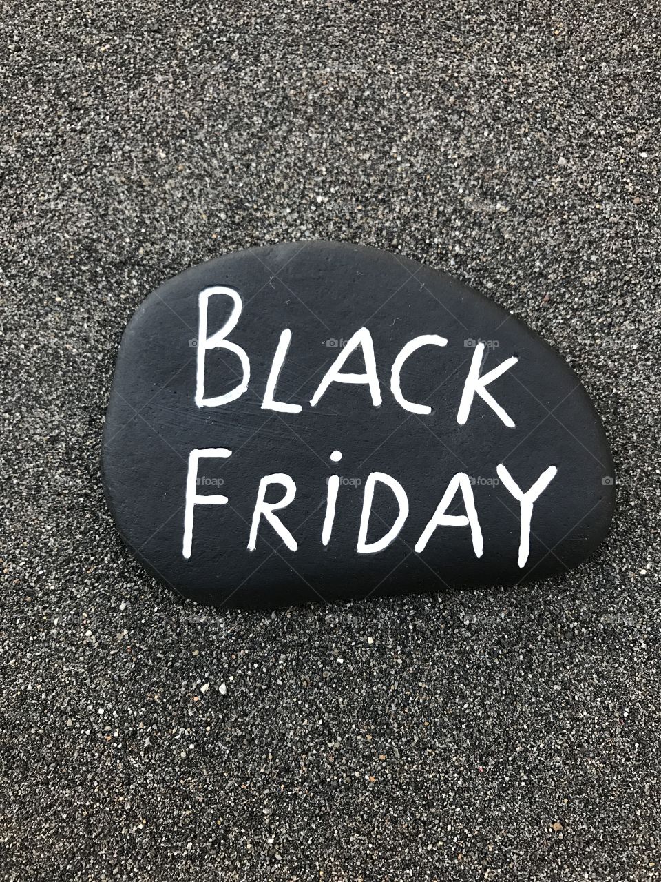 Black Friday on a carved and painted stone 