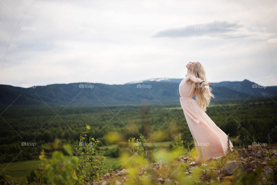 Pretty woman posing at grassy land