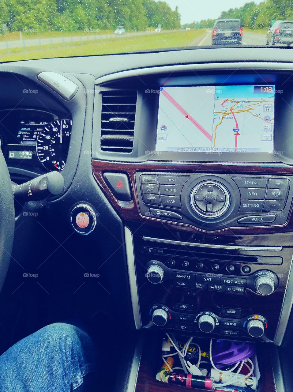 Car dashboard driving on road.