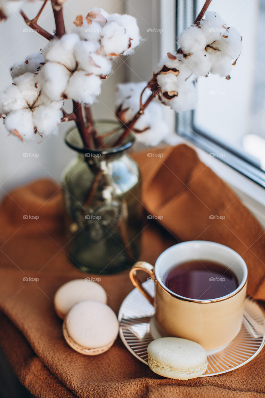 coffee and macaroon cakes by the window