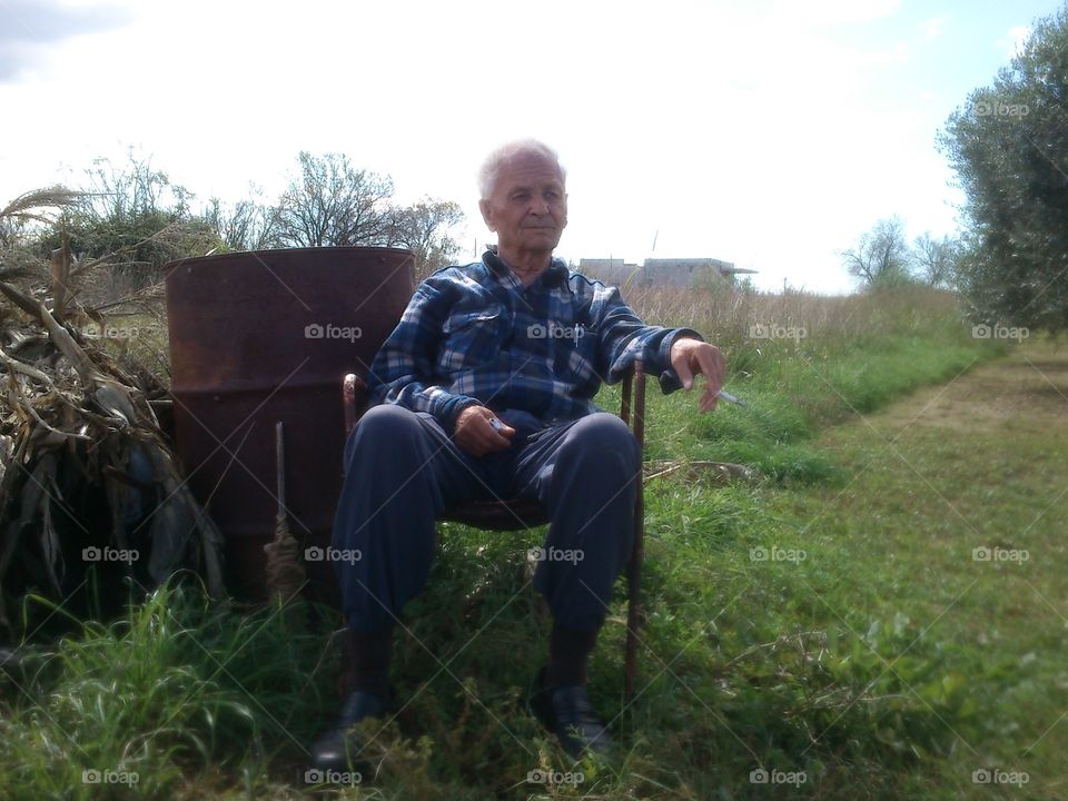 Old man. my grandpa chilling at the village