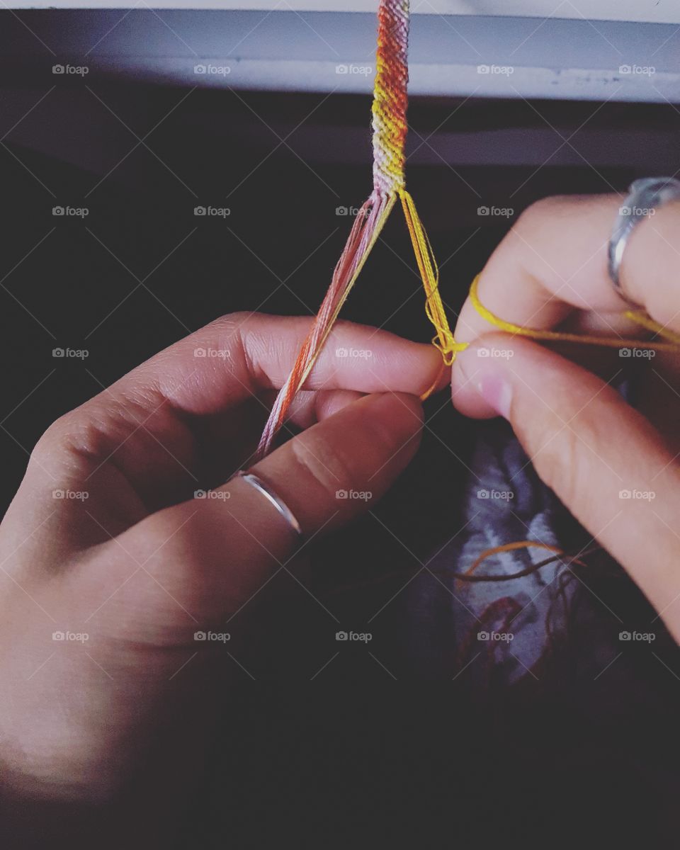 A woman knitting with thread