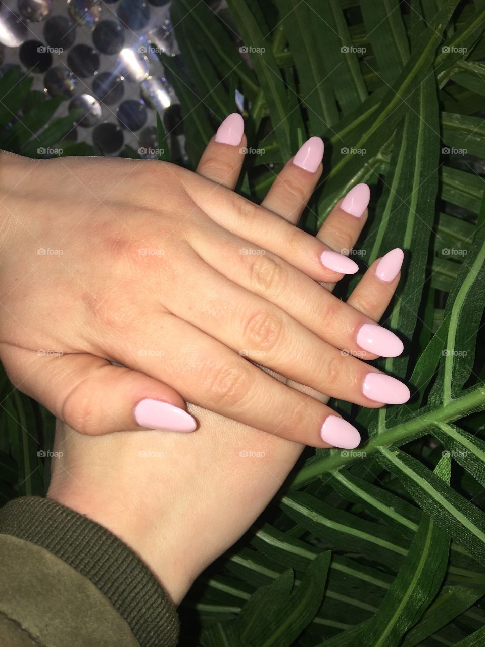 Pink Acrylic Nails on Green Leaves
