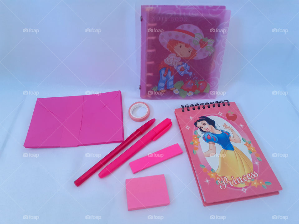 pink notebook with pencil and post it