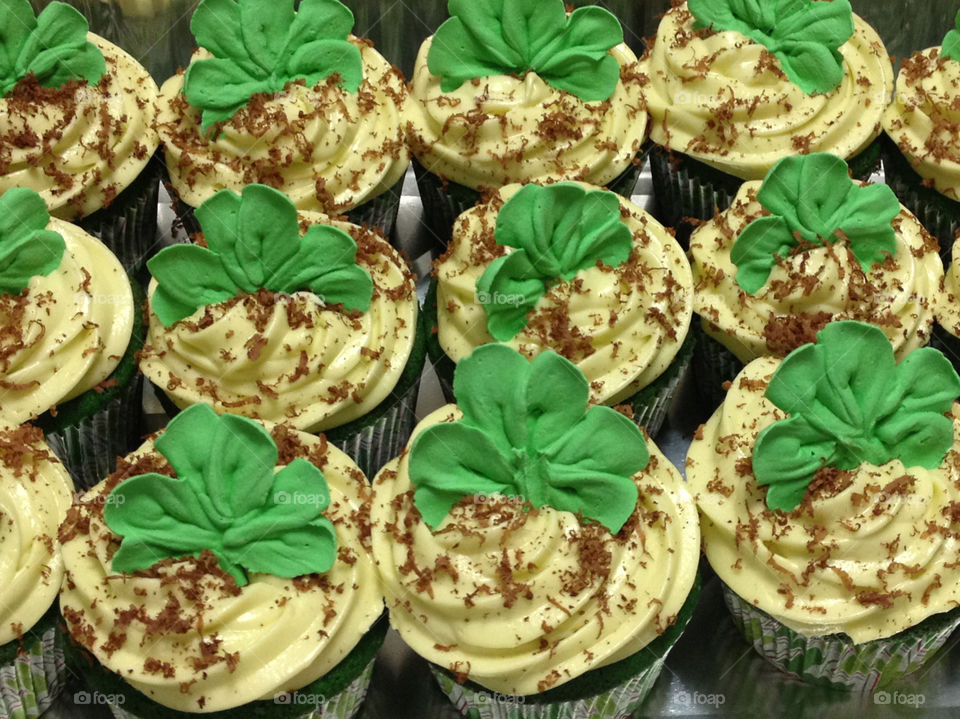 Green velvet cupcakes decorated with green frosting and a clover for St. Patrick’s Day